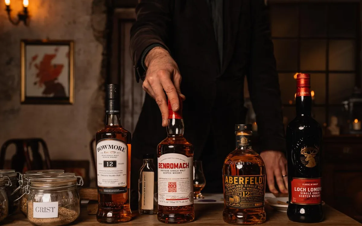 Four whiskey glasses in a row on a tasting mat